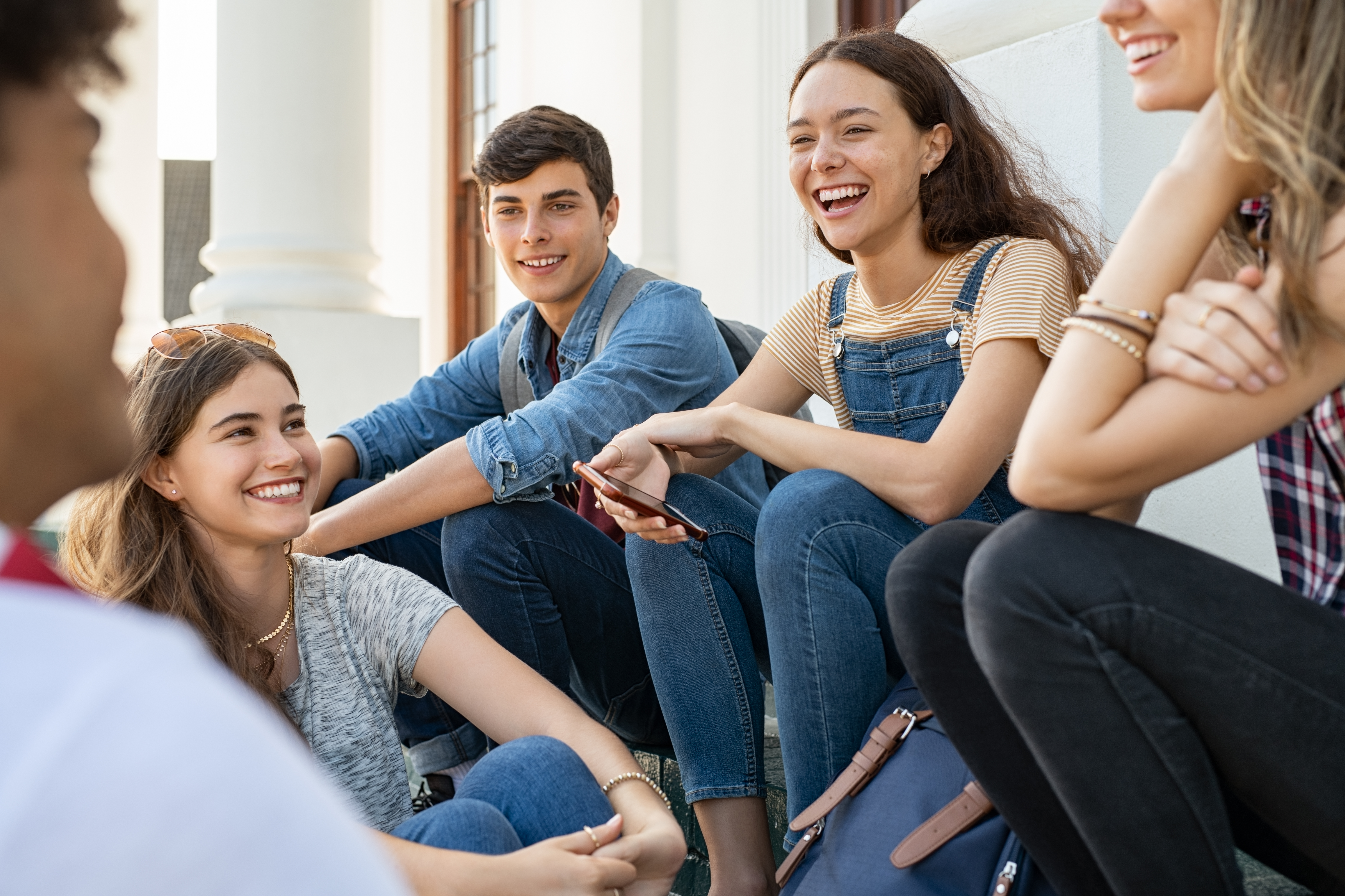 teenager-friends-sitting-together-and-laughing-2022-02-02-03-59-37-utc.jpg